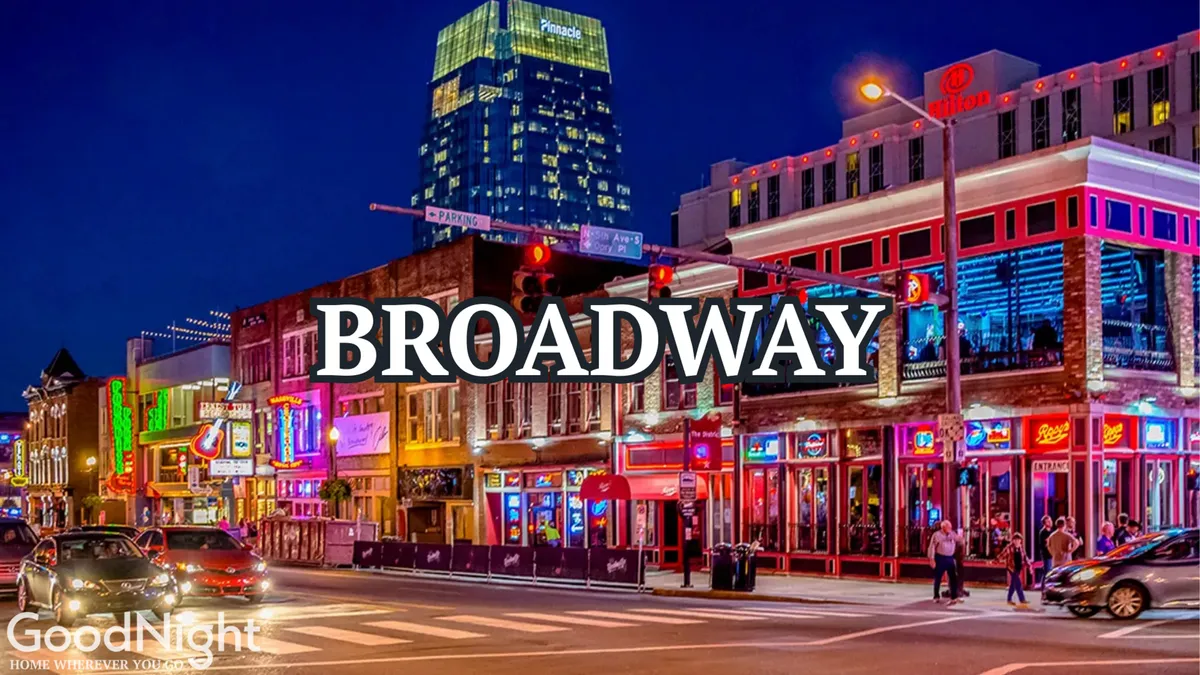 A bustling Nashville street scene at night, filled with neon signs above lively restaurants, people strolling, and a backdrop of skyscrapers. The energy of live music, dining, and nightlife is palpable, capturing the iconic atmosphere of downtown and Broadway.